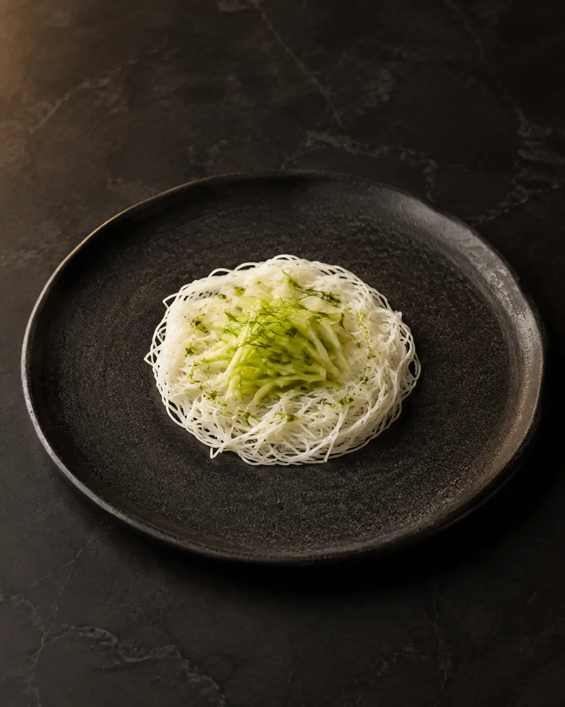 Green mango idiyappam, plated at NIRĀVA